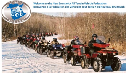 A group of people riding atvs on top of snow covered ground.