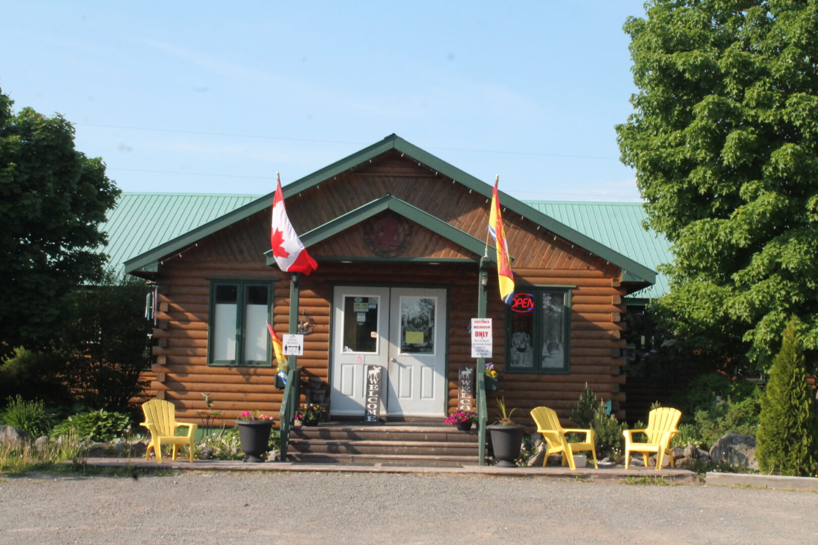 A building with chairs and flags on the front.
