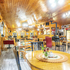 A restaurant with many tables and chairs in it