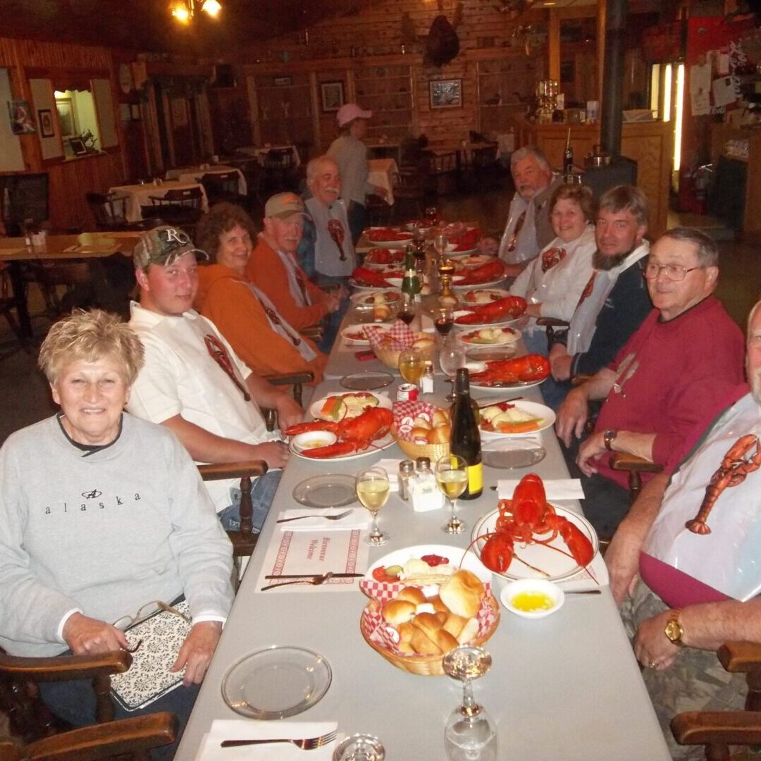 A group of people sitting at a table with plates and glasses.